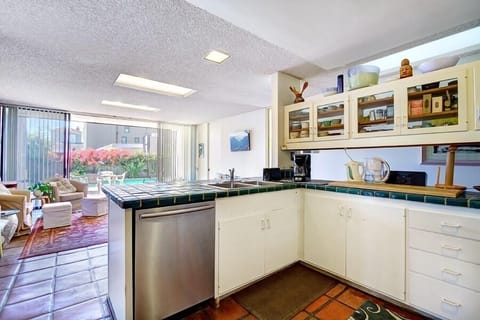Sliding glass door opens out to pool and patio area from kitchen/family combo