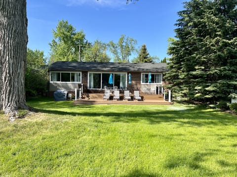 Two-level trex deck with three umbrella tables for 20.