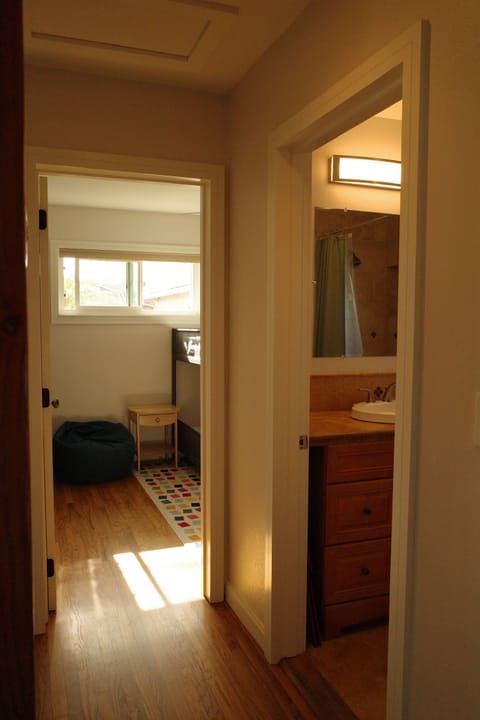 Hallway to bedroom 1 and 2, and shared bathroom with tub/shower