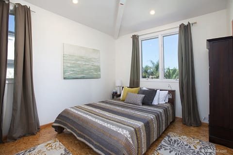 One upstairs bedroom has a queen size bed and armoires