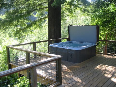 Relax in hot tub under the redwood with view of river. 