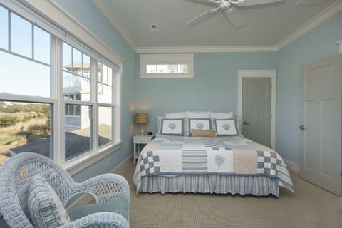 King-sized bed with a view of the marsh