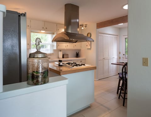 Newer Washer & Dryer are behind white doors to the left and a peek of back door