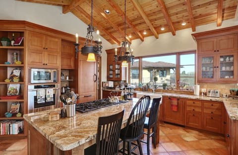 Kitchen breakfast bar comfortably seats up to 3 people, off of dining room.