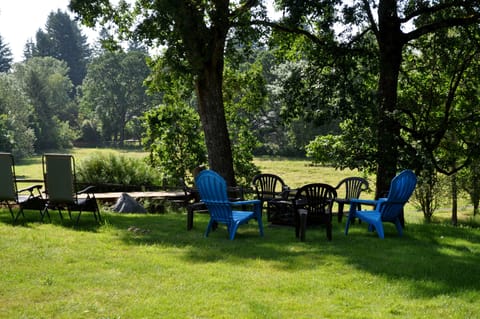 Outdoor screened fireplace with grill ready for evening s'mores.