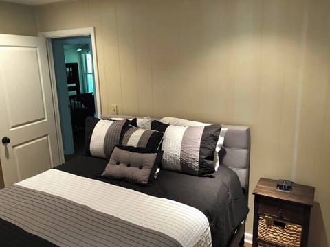 Hall bedroom showing full bed and nightstand