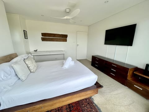 Master bedroom with queen bed, ensuite, TV and aircon
