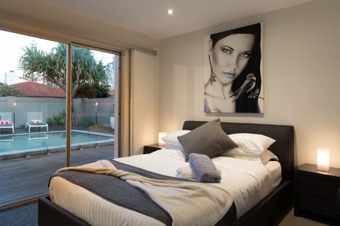 Queen size bed in Bedroom 2 which also overlooks the pool. 