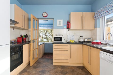 Kitchen with luxury 'white' goods including  dishwasher.  Laundry Room beyond.