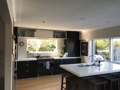 kitchen with sliding doors to pool, bbq and outdoor lounge