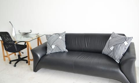 Work space and couch area leads out to a balcony to watch the sea and sunsets!