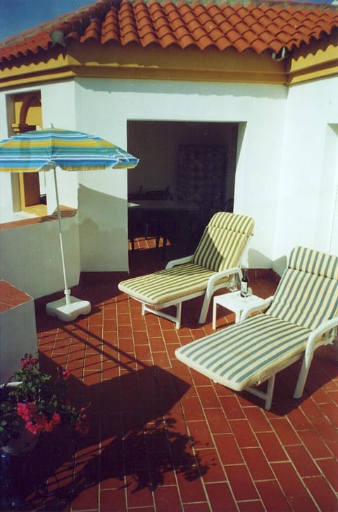 Large sunny s/west facing terrace shaded room with seating for eating al fresco.