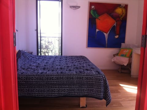 The colorful master bedroom with hard wood floor.