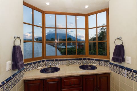 Shared bathroom with double sinks and spectacular views.