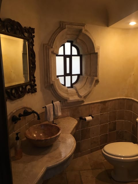 Powder room with travertine marble.