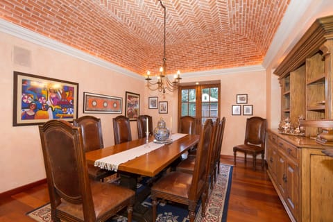Dining room with intricately designed herringbone brick ceiling and seats 10.