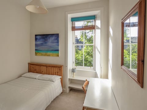 Second double bedroom with desk and chair.