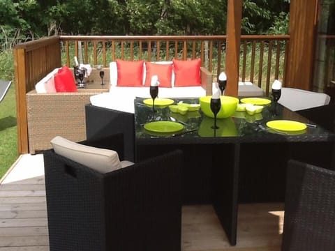 large outdoor decking with garden furniture and private hot tub