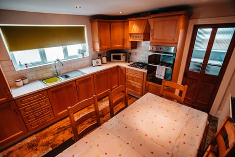 Well equipped kitchen with utility room to the rear