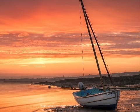 The tidal estuary at sunset. The slipway to the beach is opposite the cottage