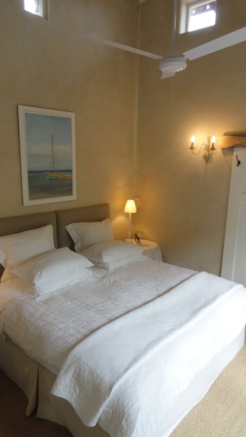 Bedroom with king size bed and doors leading to garden