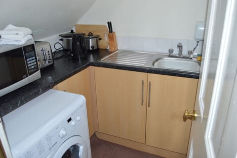 Bijou kitchenette with fridge, microwave, kettle, washer/dryer. NO oven or hob