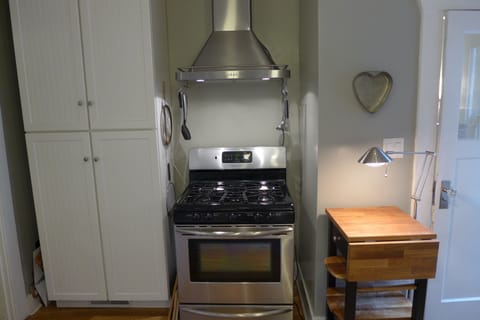 Gas range with vented hood and side prep table.