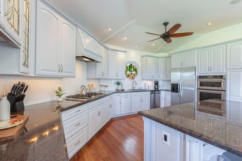 Bright, elegant kitchen with high-end finishes, abundant storage, and direct access to dining and living areas.