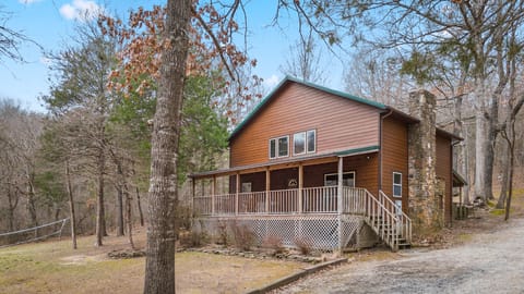 2 story cabin with large front deck overlooking the volleyball net and horseshoe