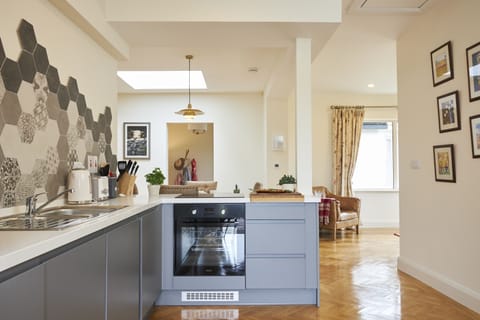 Kitchen with washer-dryer, fridge freezer, oven, microwave and hob
