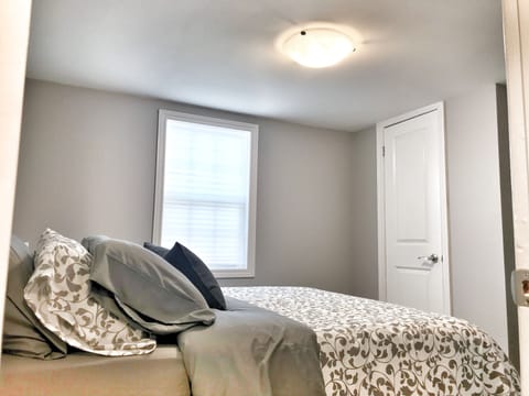 First bedroom with Q bed, plenty of closet space, hangers and drawer space.