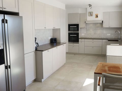 Room, Countertop, Kitchen, Property, Furniture, Cabinetry, Major Appliance, Floor, Refrigerator, Tile