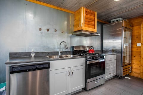 This is a true chef's kitchen, packed with gleaming modern appliances, including a commercial-grade range top and oven!