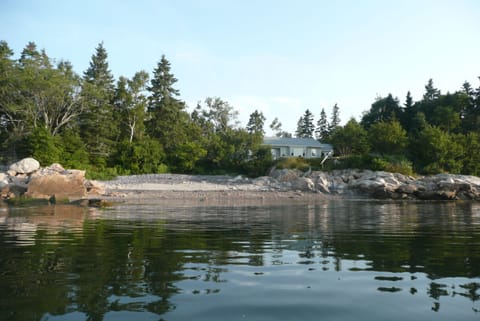 View of the house and west side beach in front on a kayak at high tide