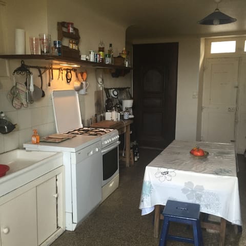 The kitchen with stove, oven, microwave, dishwasher, refrigerator; door to rue.