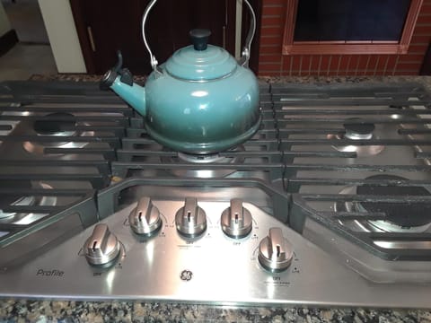 Five-burner gas range in the kitchen.