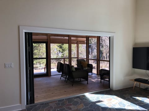 Panoramic doors fully opened to screen porch