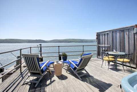 Large private bayfront deck with hot tub and lounge chairs