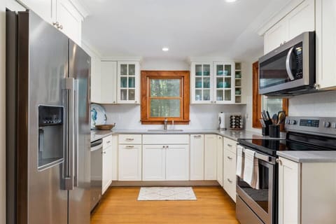 The Kitchen is equipped with stainless Whirlpool appliances and a large sink with a garbage disposal
