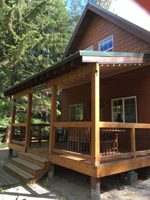 Covered front porch with Teak dining table and rocking chairs