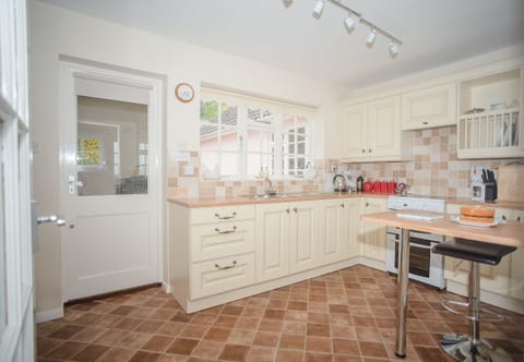 Fully equipped kitchen with garden and sea views.