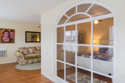 Cozy sofa and queen bed with linen toile quilt
