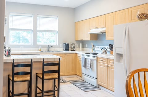 The kitchen is full stocked with appliances and basic supplies.
