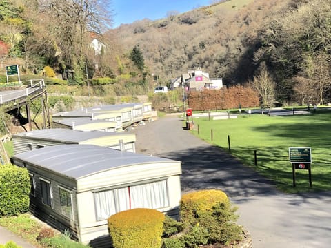 Static caravans overlook the camp field,  West Lyn River & Exmoor National Park