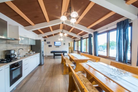 Large dining tables and a spacious kitchen
