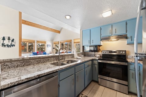 Updated full-size kitchen with stainless steel appliances and granite countertops.