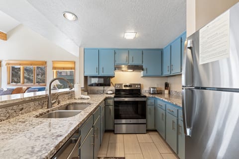 Updated full-size kitchen with stainless steel appliances and granite countertops.