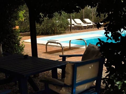 Beautiful pool surrounded by sunbathing area and loungers