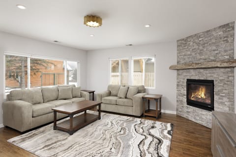 Spacious living room with fireplace 
and large flat screen TV