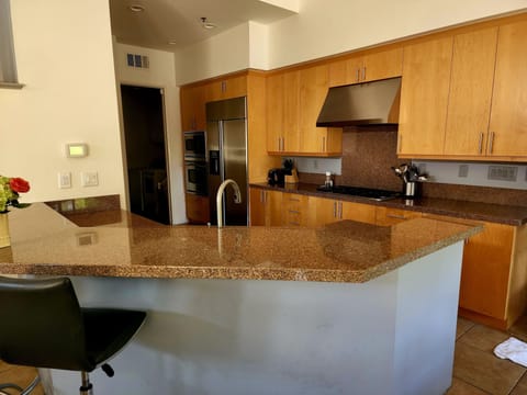 Kitchen includes built in stove, oven, large refrigerator and microwave